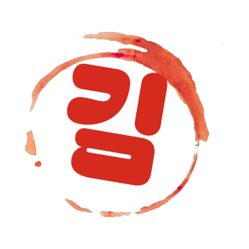 Dolsot bibimbap served in a black stone pot with carrots, spinach, bean sprouts, gosari, a raw egg yolk, and gochujang over steamed white rice